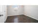A clean bedroom features light gray walls, wood-look floors, and a window at 2398 Chancery Mill Ln, Buford, GA 30519