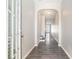 Inviting hallway features an arched entryway and stylish wood-look flooring at 2398 Chancery Mill Ln, Buford, GA 30519