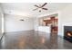 Open-concept living room with fireplace flows into the kitchen with stainless appliances at 2398 Chancery Mill Ln, Buford, GA 30519