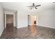 Large main bedroom with ceiling fan and dark hardwood flooring at 2398 Chancery Mill Ln, Buford, GA 30519