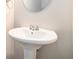 Simple powder room featuring a pedestal sink and oval mirror at 2398 Chancery Mill Ln, Buford, GA 30519