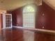 Bedroom with a large arched window with white blinds, and french doors at 294 Hascall Nw Rd, Atlanta, GA 30309
