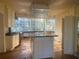 Kitchen with a large island, expansive windows, and outdated cabinets needing renovation at 294 Hascall Nw Rd, Atlanta, GA 30309