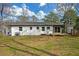 Backyard with a newly built deck, manicured lawn, and newly painted brick home at 3235 Bluebird Ln, Decatur, GA 30032