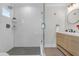 Modern bathroom with glass enclosed shower, wood vanity, and neutral tile at 3235 Bluebird Ln, Decatur, GA 30032