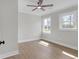 Bright bedroom with hardwood floors, ceiling fan, and two windows at 3235 Bluebird Ln, Decatur, GA 30032