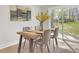 Elegant dining area with a wooden table, seating for four, and sliding glass doors to the yard at 3235 Bluebird Ln, Decatur, GA 30032