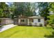 Craftsman-style bungalow with fresh exterior paint, modern color accents, and an inviting front lawn at 3235 Bluebird Ln, Decatur, GA 30032