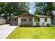 Charming bungalow with a blue front door, modern colors, and a welcoming front porch at 3235 Bluebird Ln, Decatur, GA 30032