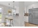 Modern kitchen with stainless steel appliances, white cabinets, and a breakfast bar at 3235 Bluebird Ln, Decatur, GA 30032