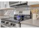 Updated kitchen with stainless steel oven, range, and vent hood, with backsplash at 3235 Bluebird Ln, Decatur, GA 30032