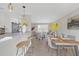 Open kitchen and dining area with a breakfast bar, modern appliances, and stylish decor at 3235 Bluebird Ln, Decatur, GA 30032