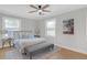 Stylishly furnished main bedroom with hardwood floors, two windows, and seating at 3235 Bluebird Ln, Decatur, GA 30032
