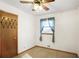 This bedroom features a ceiling fan, carpet, and a door with unique metal accents at 4676 Ridgewood Dr, Forest Park, GA 30297
