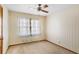 The bedroom features wallpaper, carpeted floors, a ceiling fan, and natural light at 4676 Ridgewood Dr, Forest Park, GA 30297