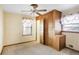 This bedroom offers carpet, a ceiling fan, a window, and a built-in closet with storage at 4676 Ridgewood Dr, Forest Park, GA 30297