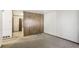 This room features a paneled accent wall and carpeted floors leading to another room at 4676 Ridgewood Dr, Forest Park, GA 30297