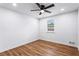 A bright bedroom featuring hardwood floors, white walls, and a ceiling fan at 1150 Rankin St # 6H, Stone Mountain, GA 30083