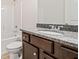 Full bathroom with tub, shower, dark vanity with gray granite counters at 206 Lotus Ln, Covington, GA 30016