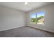 Well-lit bedroom featuring a large window and soft carpet at 206 Lotus Ln, Covington, GA 30016
