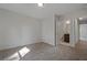 Bedroom with neutral walls, tan carpet, and multiple doorways at 206 Lotus Ln, Covington, GA 30016