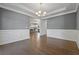 Dining room featuring elegant wainscoting, a chandelier, and hardwood floors at 206 Lotus Ln, Covington, GA 30016