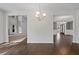 Large dining room showcases beautiful hardwood floors, lighting, and access to other living areas at 206 Lotus Ln, Covington, GA 30016