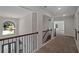 Upstairs hallway with chandelier and wrought iron railing at 206 Lotus Ln, Covington, GA 30016
