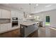 Modern kitchen with stainless steel appliances, custom backsplash, and large island at 206 Lotus Ln, Covington, GA 30016
