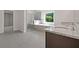 Main bathroom featuring double sinks, granite counters, walk-in shower, and soaking tub at 206 Lotus Ln, Covington, GA 30016