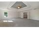 Large main bedroom with tray ceiling and doorway to hallway at 206 Lotus Ln, Covington, GA 30016