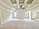 A large bedroom with coffered ceiling and ceiling fan at 218 Lotus Ln, Covington, GA 30016