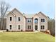 Stunning two-story brick home with a well-manicured lawn and an inviting front entrance at 218 Lotus Ln, Covington, GA 30016