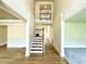 Bright foyer features a staircase with wood railing, hardwood flooring, and soaring ceilings at 218 Lotus Ln, Covington, GA 30016