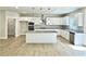 Modern white kitchen features an island with seating, stainless steel appliances, and custom backsplash at 218 Lotus Ln, Covington, GA 30016