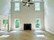 Living room with two-story ceiling, fireplace, and hardwood flooring at 218 Lotus Ln, Covington, GA 30016