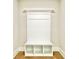 Mudroom area with custom white built-in shelving and seat at 218 Lotus Ln, Covington, GA 30016