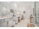 Bright bathroom features marble floors, dual vanities, a makeup vanity, and a glass-enclosed walk-in shower at 233 Retreat Ln, Canton, GA 30114