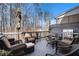 Outdoor deck with comfortable seating, grill, and wooded view at 233 Retreat Ln, Canton, GA 30114