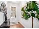 Inviting foyer with hardwood floors, decorative mirror, and bright natural light entering through the glass front door at 233 Retreat Ln, Canton, GA 30114