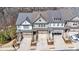 Aerial view of townhomes with attached garages and landscaped front yards at 233 Retreat Ln, Canton, GA 30114