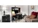 Well-organized office features black desk and chair, storage, and comfortable patterned armchair at 233 Retreat Ln, Canton, GA 30114