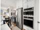 Bright kitchen featuring stainless steel appliances, and an island with bar stool seating that connects to the dining area at 233 Retreat Ln, Canton, GA 30114