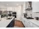 Gourmet kitchen featuring granite countertops, a gas cooktop, stainless steel appliances, and designer backsplash at 233 Retreat Ln, Canton, GA 30114