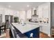 Modern kitchen with a large island, stainless steel appliances, and white cabinetry, with hardwood floors at 233 Retreat Ln, Canton, GA 30114