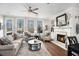 Cozy living room featuring a fireplace, large windows, hardwood floors, and comfortable seating arrangements at 233 Retreat Ln, Canton, GA 30114