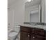 Bathroom featuring granite countertops, dark cabinets, and white plumbing fixtures at 255 Lotus Ln, Covington, GA 30016