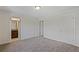 Empty bedroom featuring neutral walls, carpet, and multiple doorways at 255 Lotus Ln, Covington, GA 30016