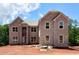 New construction two-story brick home with large windows and a symmetrical design at 255 Lotus Ln, Covington, GA 30016