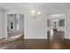 Open-concept space displaying hardwood floors and views into the formal dining room at 255 Lotus Ln, Covington, GA 30016